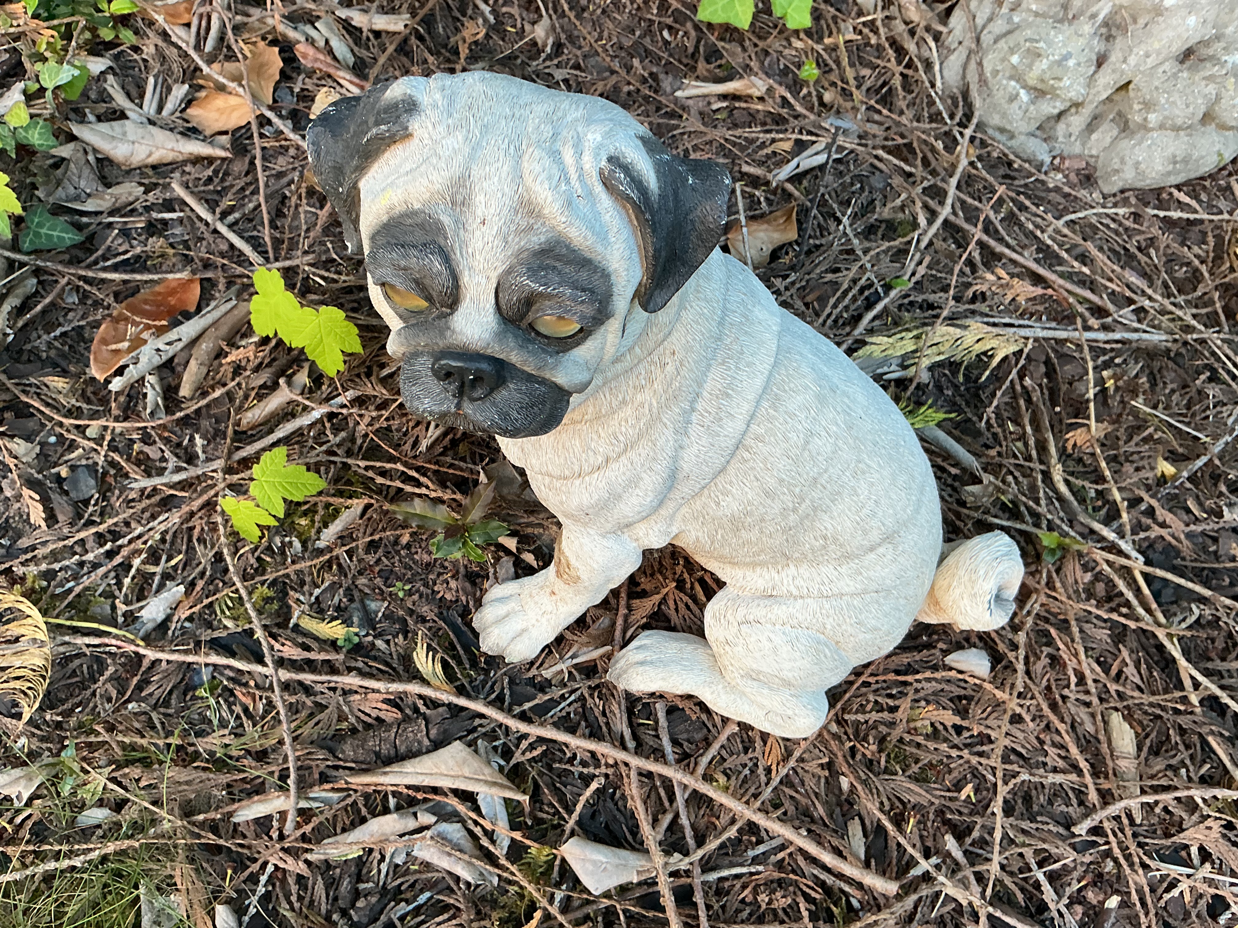A Lifelike Cast Resin Garden Figurine of a Seated Pug