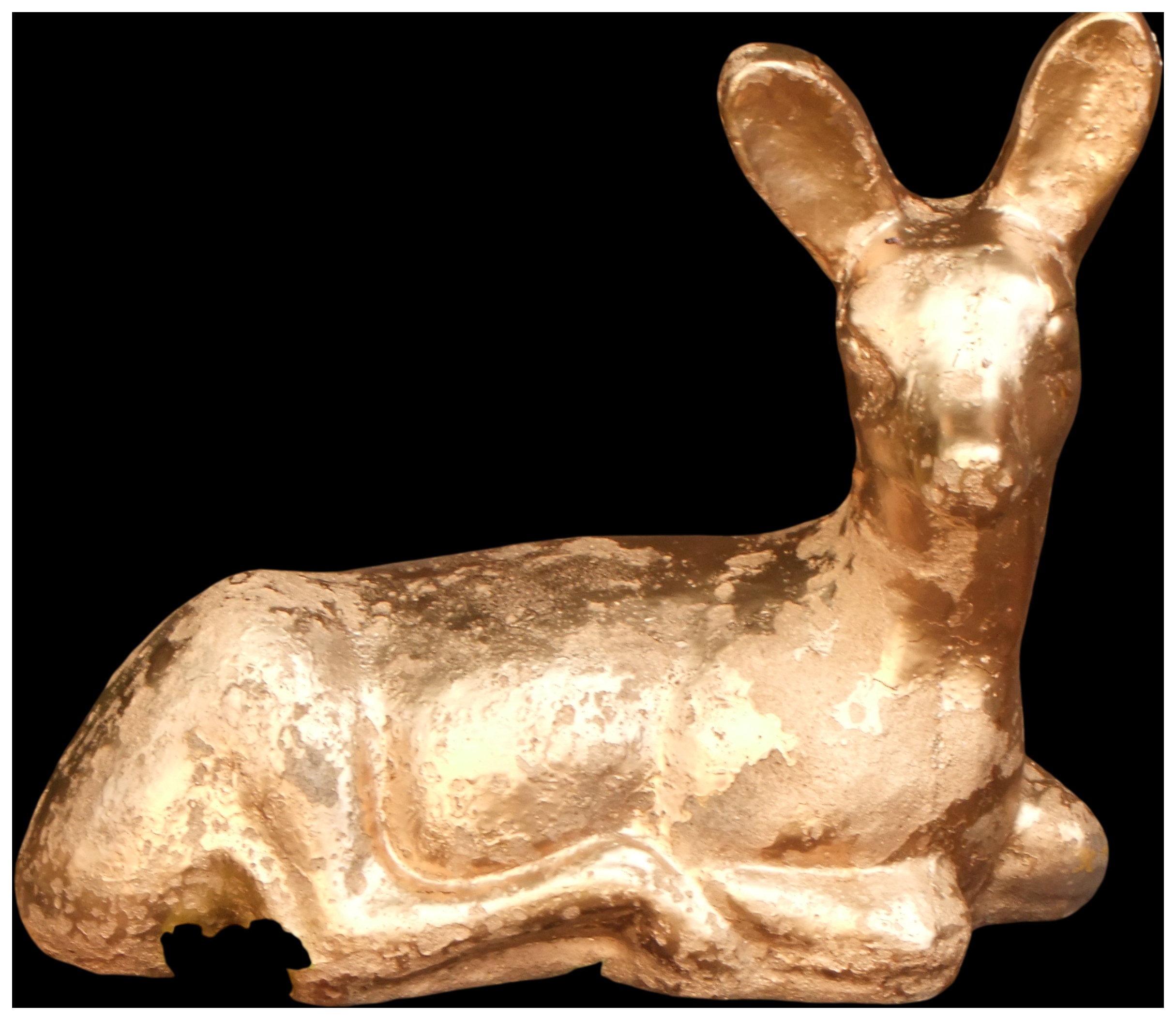 A gilded cast decorative figurine of a reclining fawn