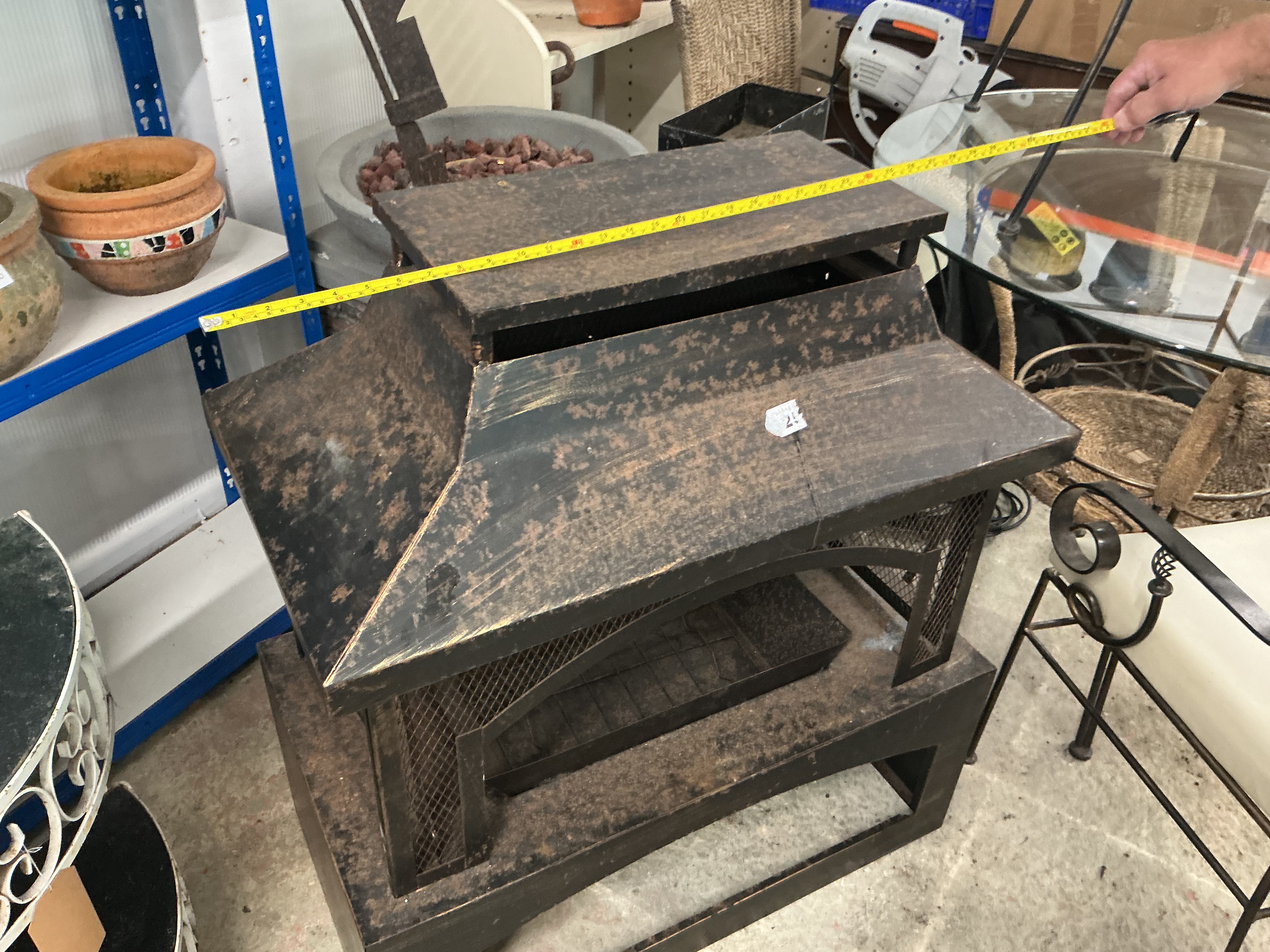A contemporary rectangular tiered outdoor metal fire pit