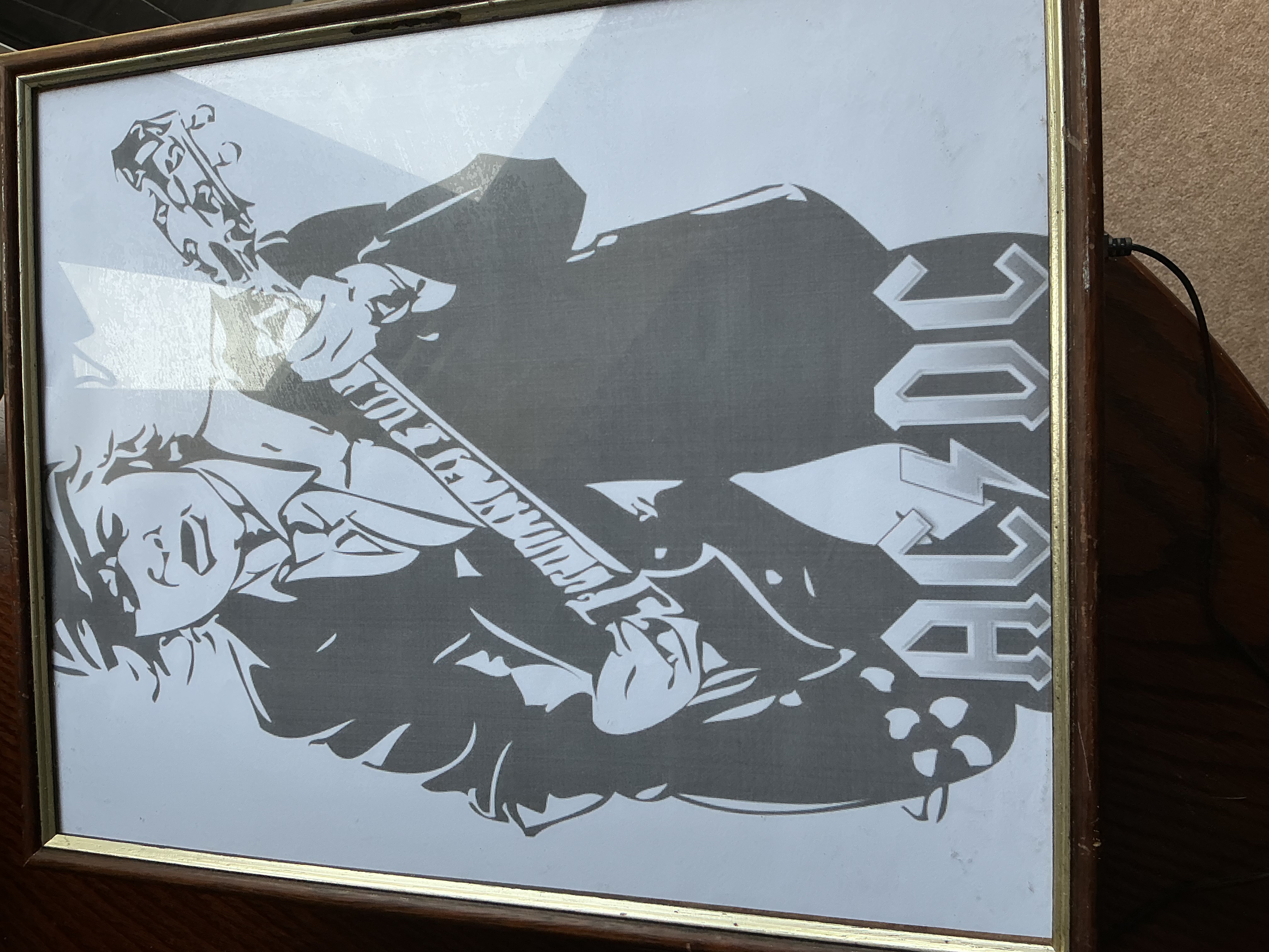 A Framed Graphic Print of AC/DC Guitarist Angus Young