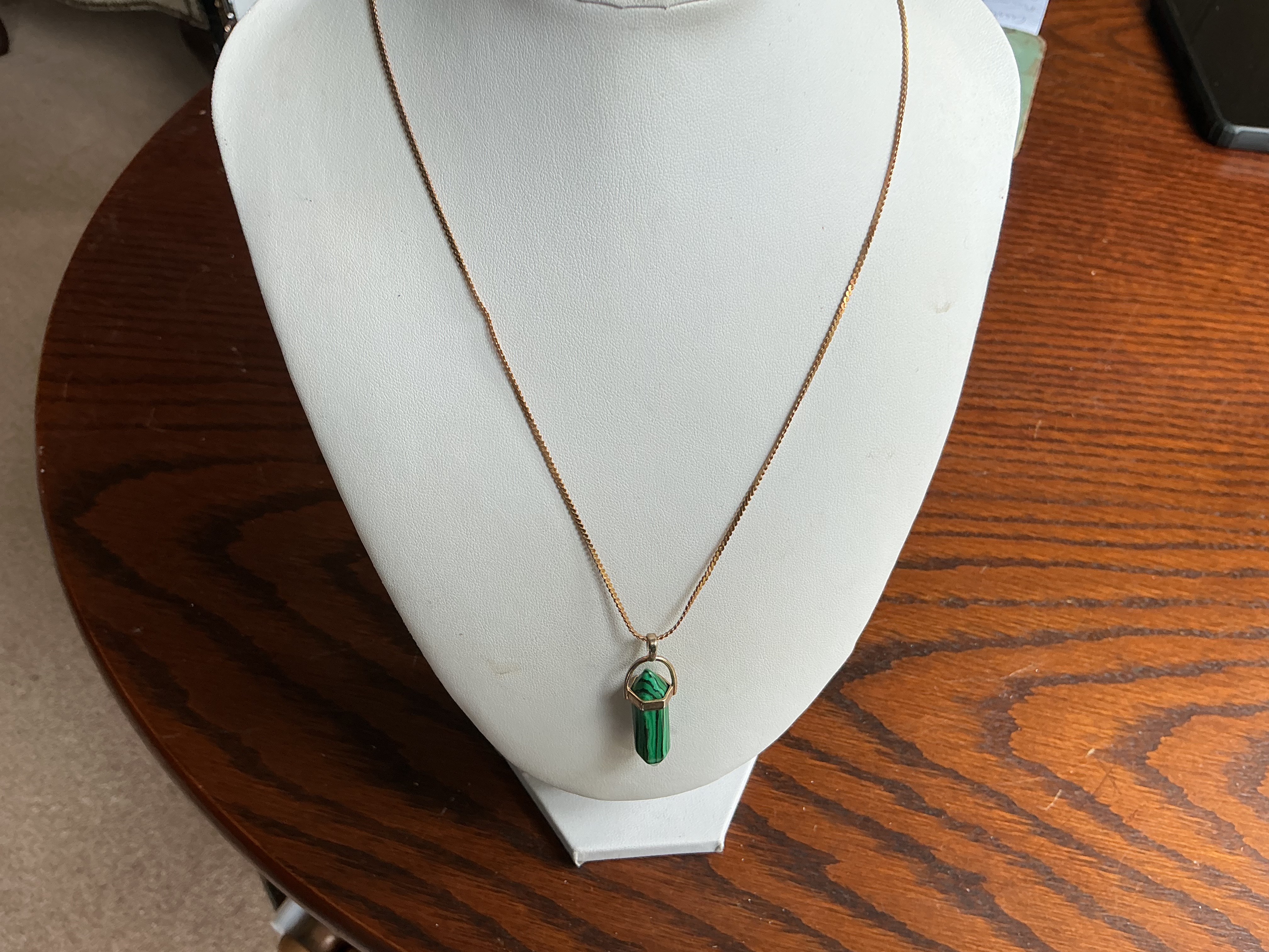 September. A Malachite Point Pendant Necklace on a Gold-Toned Chain