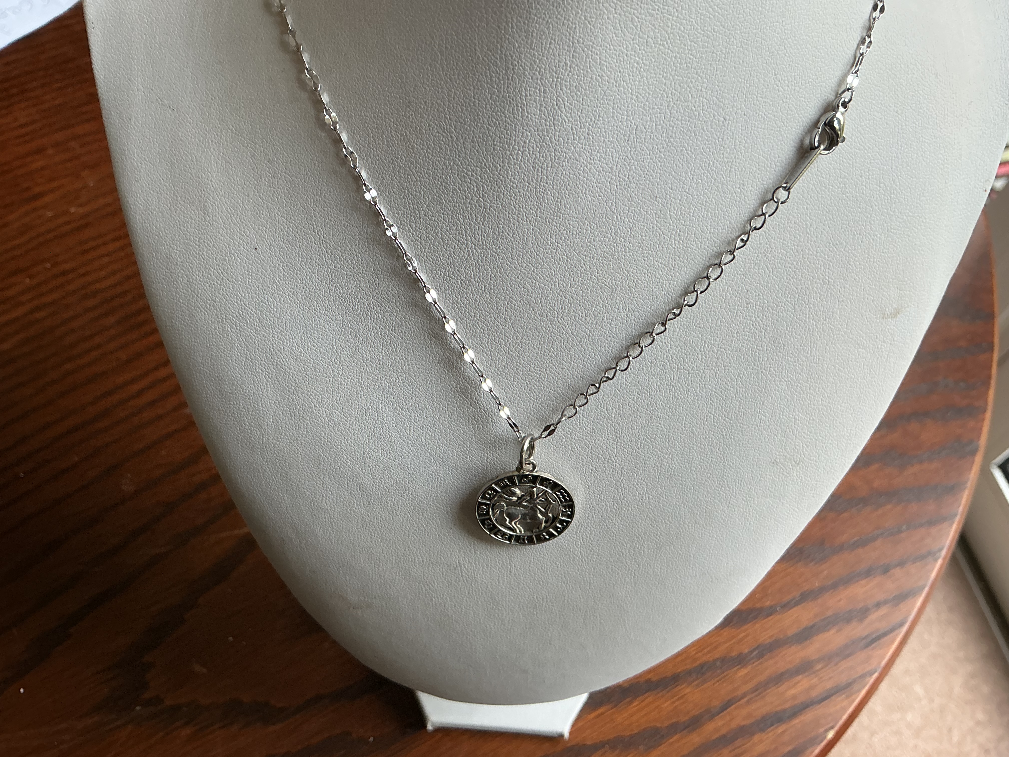 Sagittarius. A Silver-Toned Zodiac Medallion Pendant Necklace Featuring Sagittarius