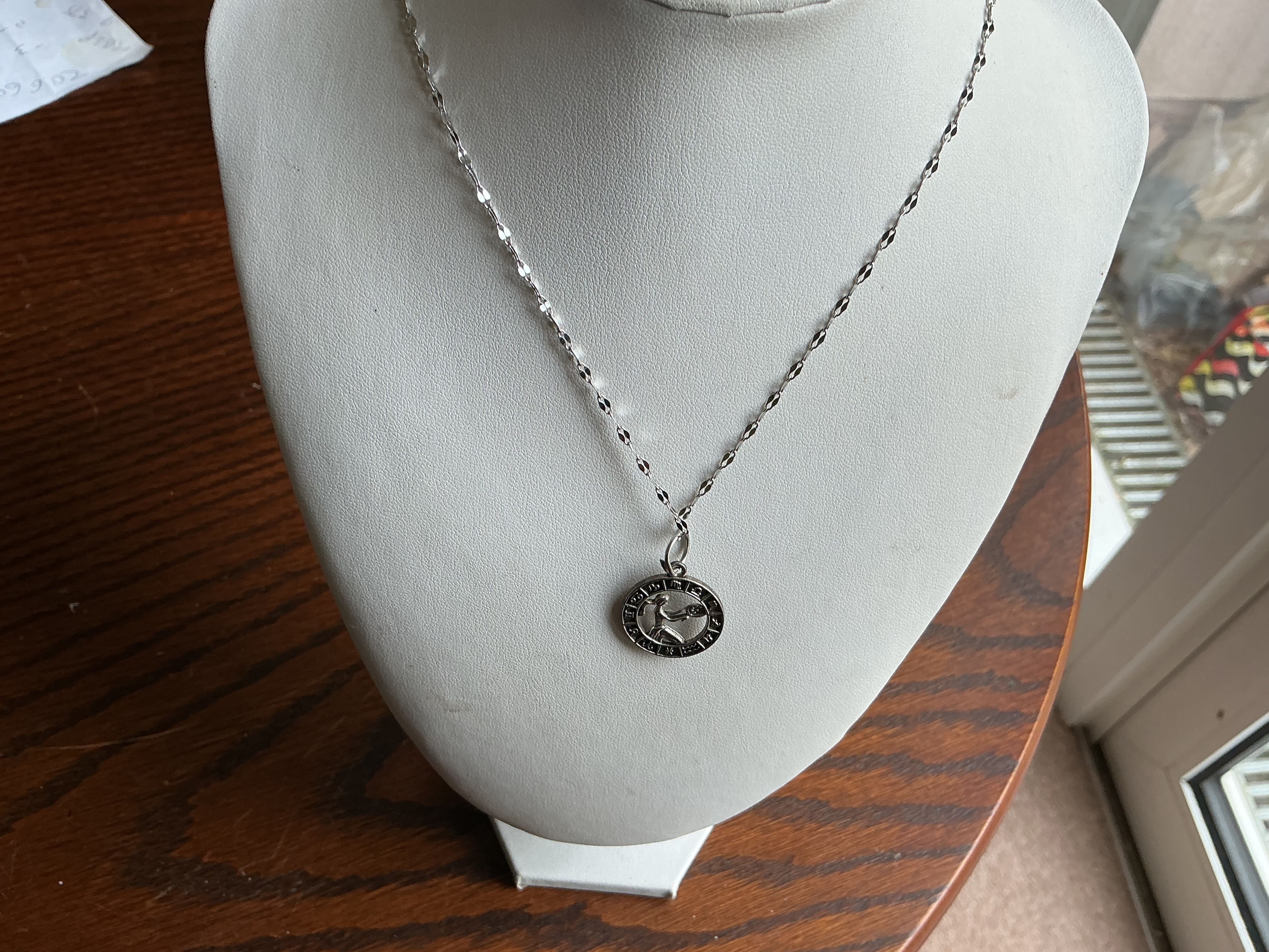 Virgo. A white metal medallion pendant on a faceted sparkle chain