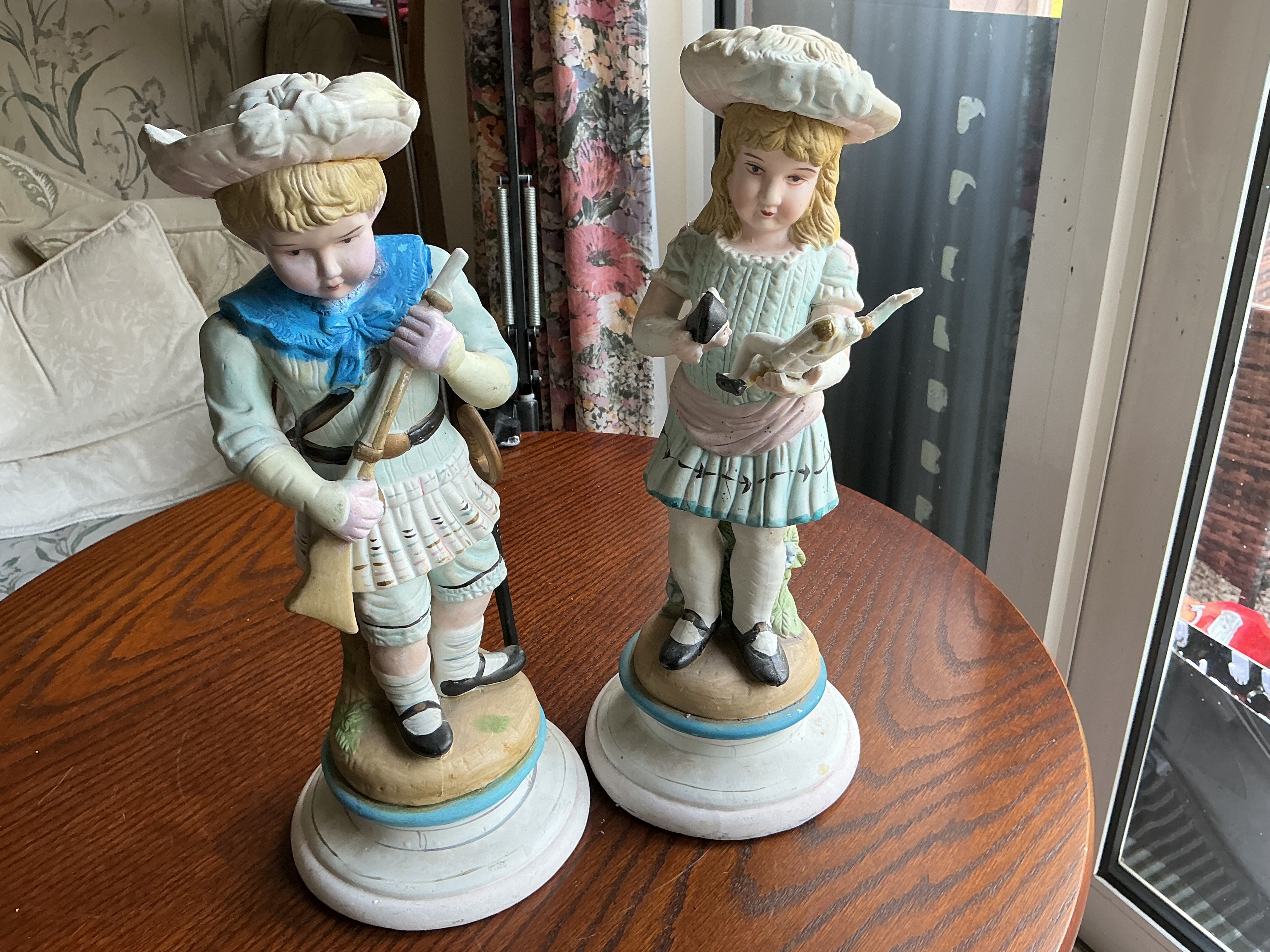 A Pair of Late Victorian Style Bisque Porcelain Highland Figurines