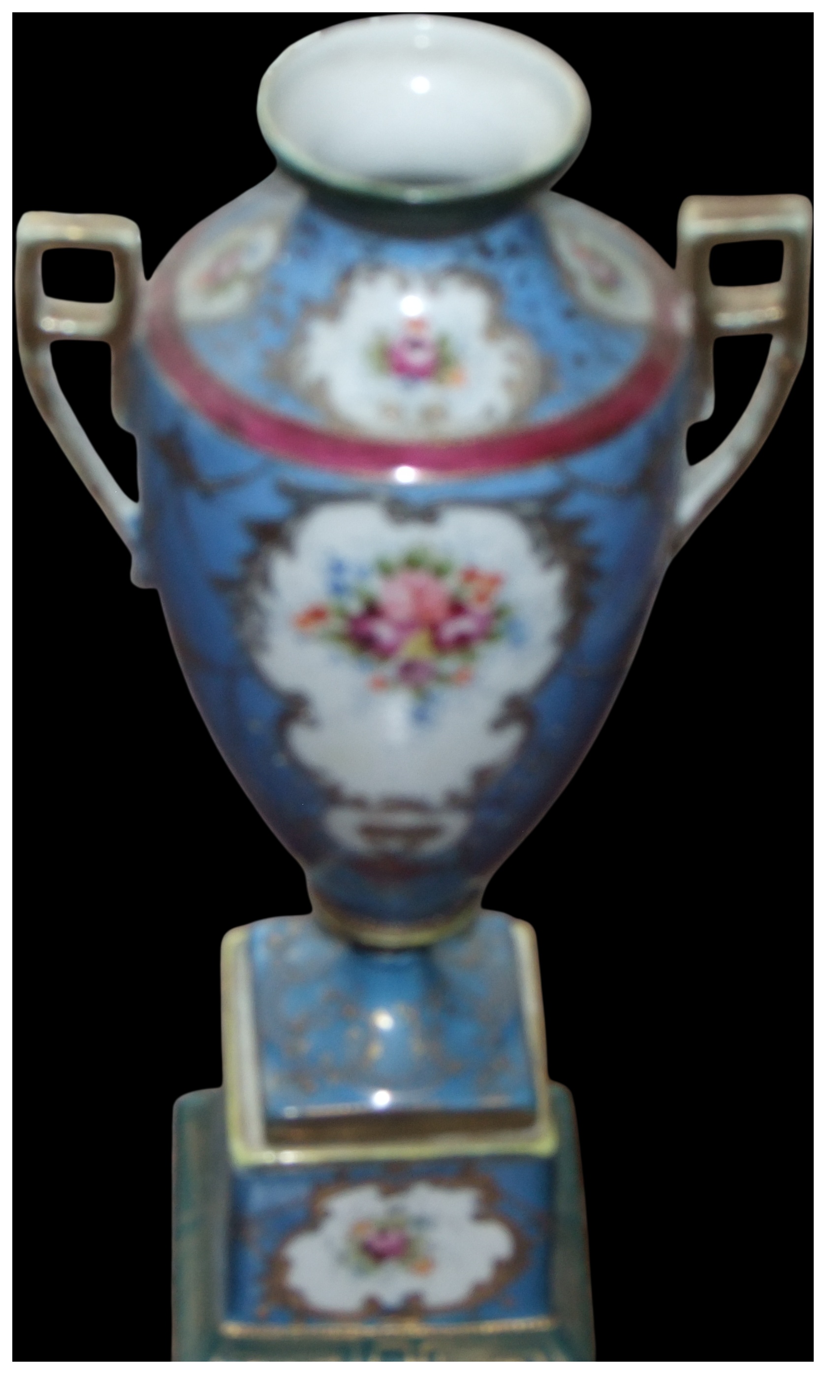 No reserve, cannot post.A twin-handled porcelain pedestal urn with hand-painted floral reserves