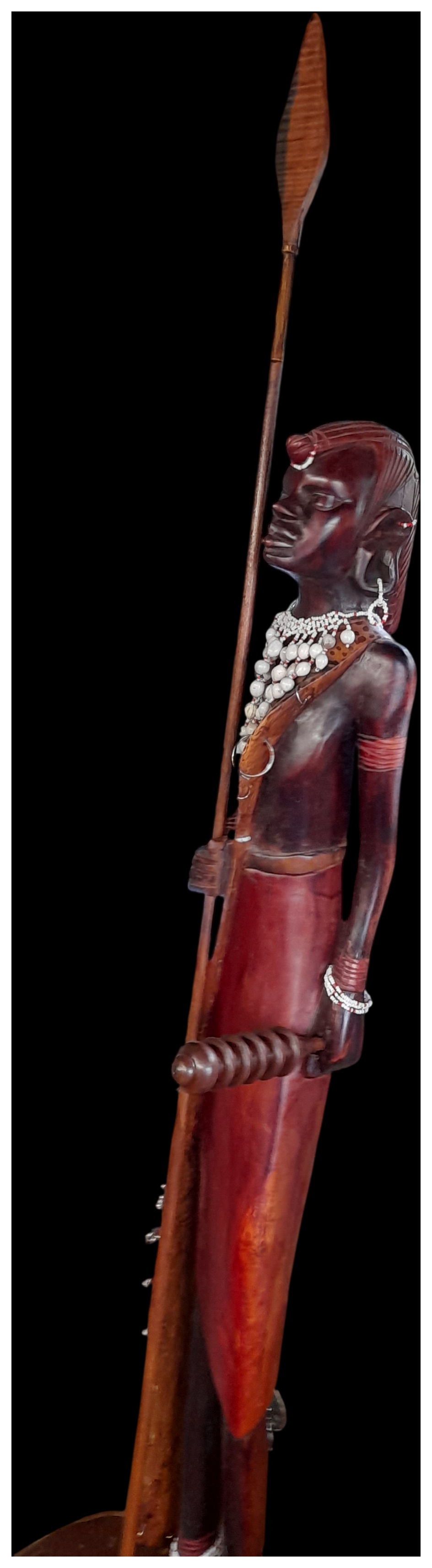 A carved hardwood standing figure of a Maasai warrior