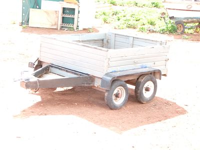 Dual Axle Utility Box Trailer with Wooden Slat Sides. A tandem-axle utility box trailer designed 