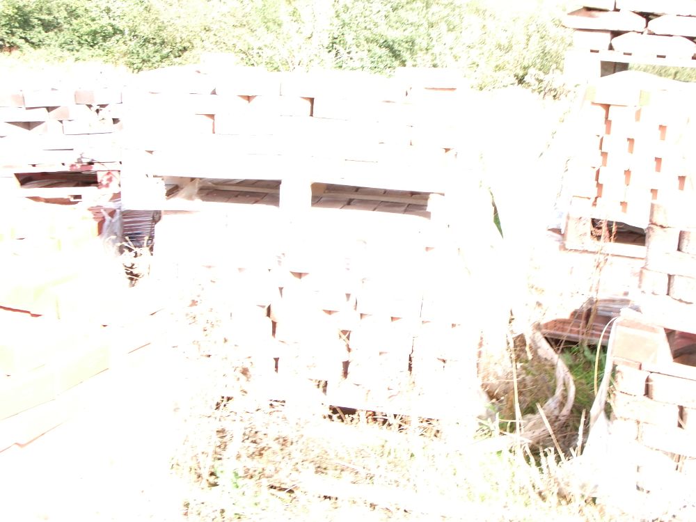 Lot 85: A Collection of Palletised Building Materials Including Bricks and Ridge Tiles