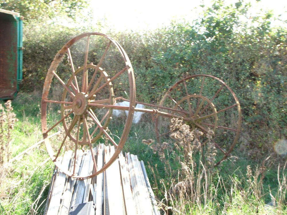 Lot 68: A Pair of Antique Iron Agricultural Wheels and Axle Assembly