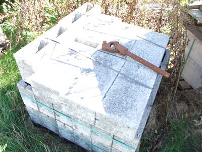 A Group of Textured Concrete Masonry Units and a Rusted Universal Joint Yoke. A lot of building 