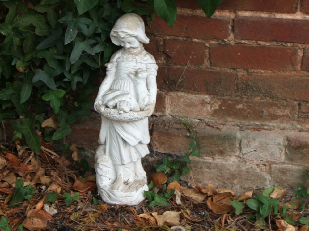 Lot 47: A Cast Composition Stone Garden Statue of a Young Girl with Puppies