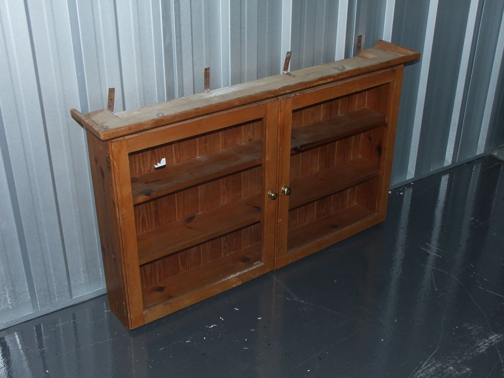 Lot 1: A wall-mounted pine glazed display cabinet