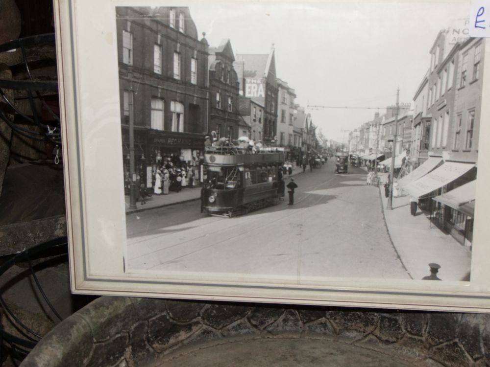 Lot 29: A Framed Black and White Silver Gelatin Photograph of a Exeter Street Scene with Trams