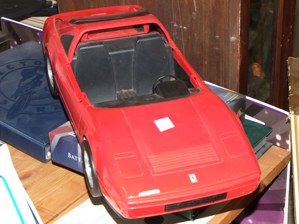 Lot 34: A Large Scale Red Plastic Barbi Toy Car