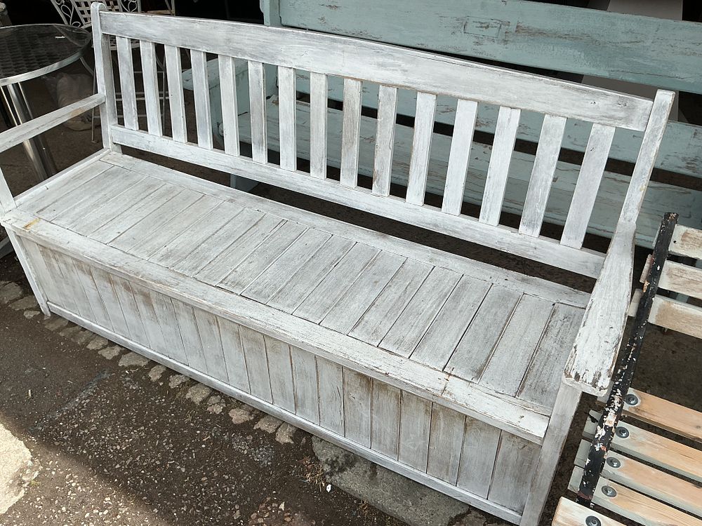 Lot 299: No reserve. A rustic white painted wood storage garden bench