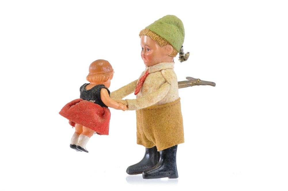 Lot 144: Schuco Man and Child Windup Tin and Celluloid, Germany