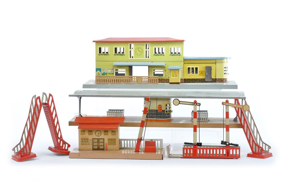 Lot 183: German Tin Train Station with Bridge and Tin Accessories by Ottmar Beckh