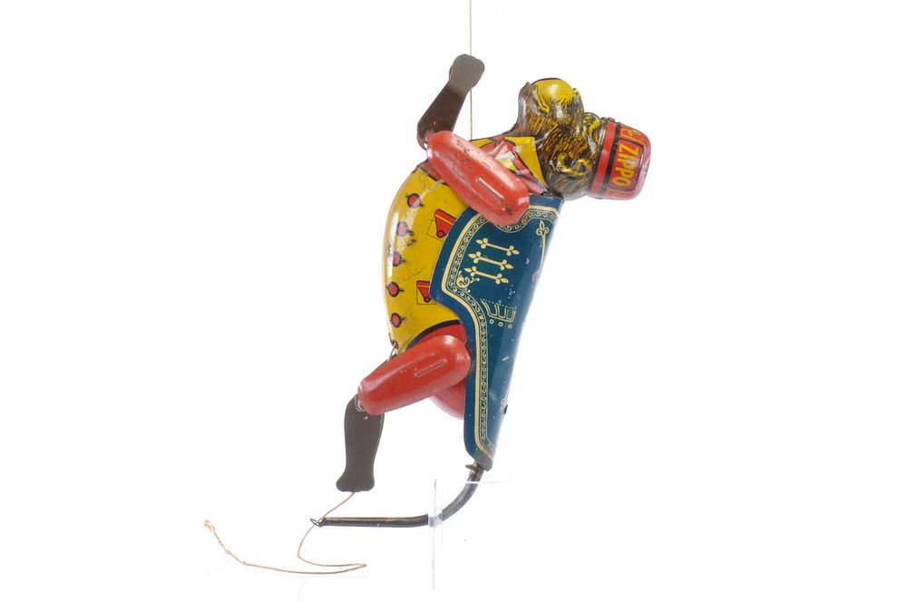 Lot 219: ZIPPO Tin Monkey Pull-Toy by Marx