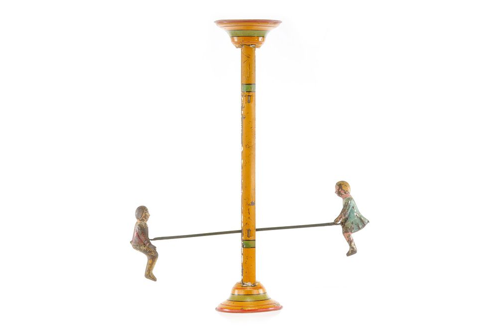 Lot 238: Gibbs Mfg. Co. Flip Over Tin Hand Painted Boy & Girl on Teeter Totter Toy