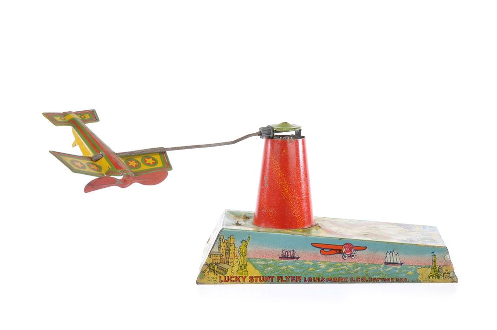 Lot 275: Marx Lucky Stunt Flyer Tin Airplane and Tower
