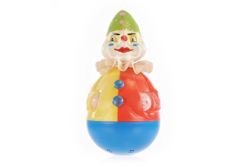 Lot 252: Plastic Rolly Dolly in Yellow, Red, Green, and Blue