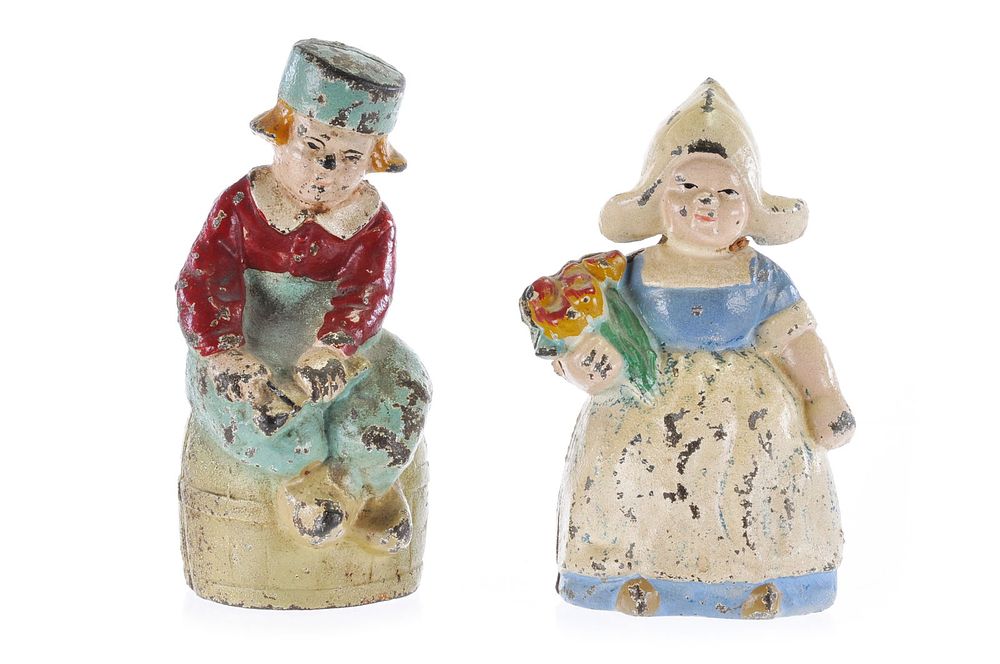 Lot 315: Hubley Dutch Boy on Carrel and Dutch Girl Holding Flowers Still Bank Set of 2