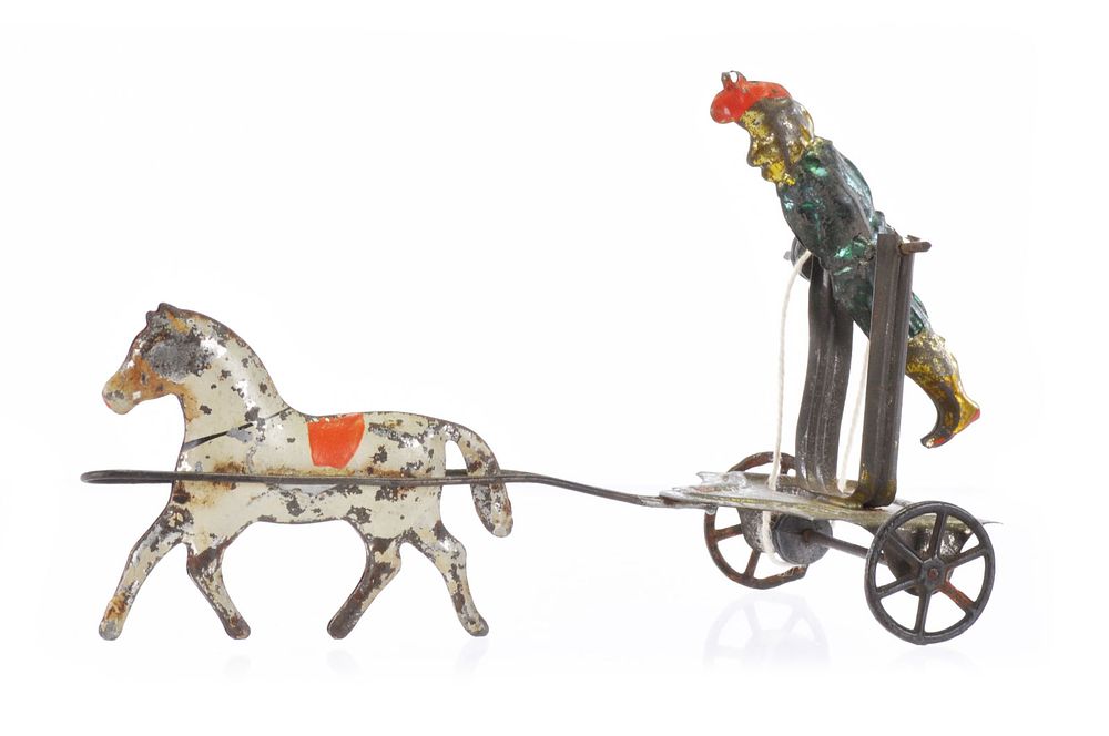 Lot 519: Early American Tin Acrobat and Horse Toy