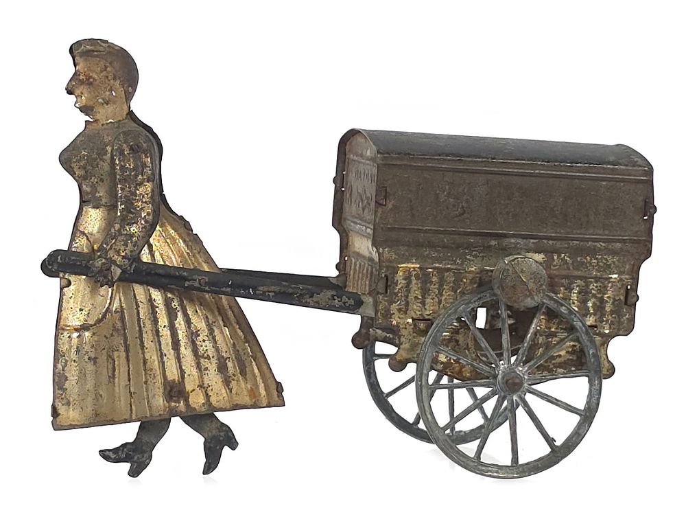 Lot 253: French Rossignol Tinplate Woman Pulling Cart Flywheel Toy