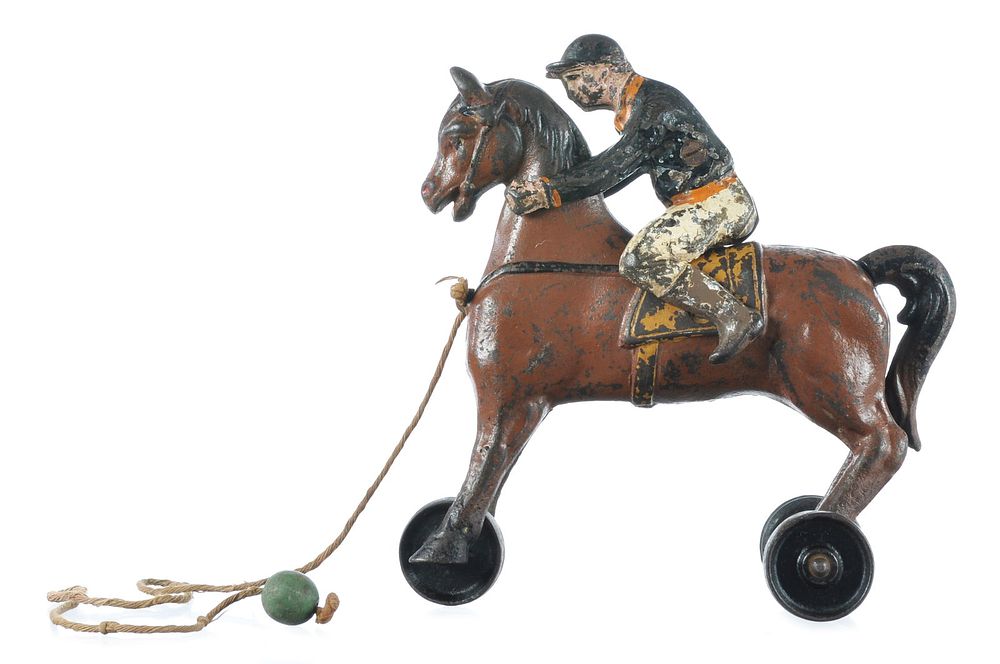 Lot 430: Globe Horse and Jockey Cast Iron Pull Toy