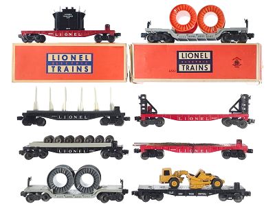 (8) Lionel Flat Cars w/Accessories Assorted. An assortment of eight Lionel flat cars with 