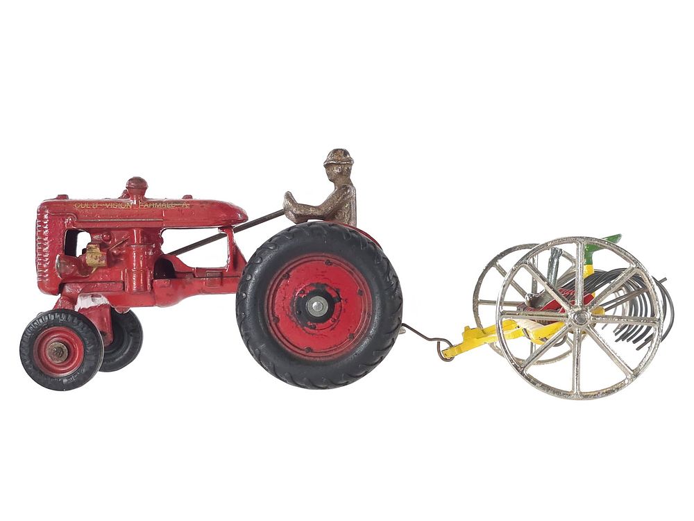 Lot 490: Arcade Toys Culti-Vision Farmall Cast Iron Tractor & Hay Rake