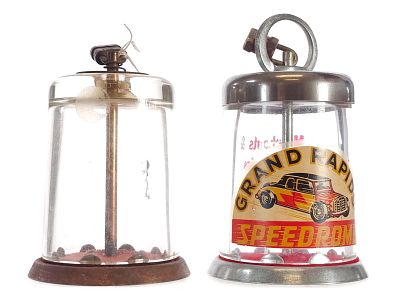 Glass Cylinder Lock-Top Banks Grand Rapids Speedrome Advertising. A pair of vintage glass 