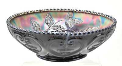 PURPLE IRIDESCENT OR CARNIVAL GLASS BOWL IN THE "DUGAN CHERRIES" PATTERN
. A purple iridescent 