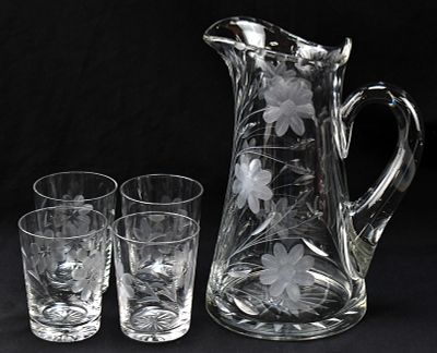 FLORAL ETCHED CRYSTAL PITCHER & TUMBLERS. A floral pattern etched crystal pitcher and four 