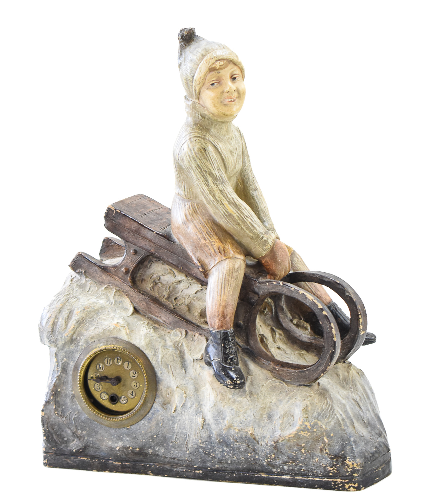 FIGURAL CHALKWARE MANTEL CLOCK OF CHILD RIDING SLED