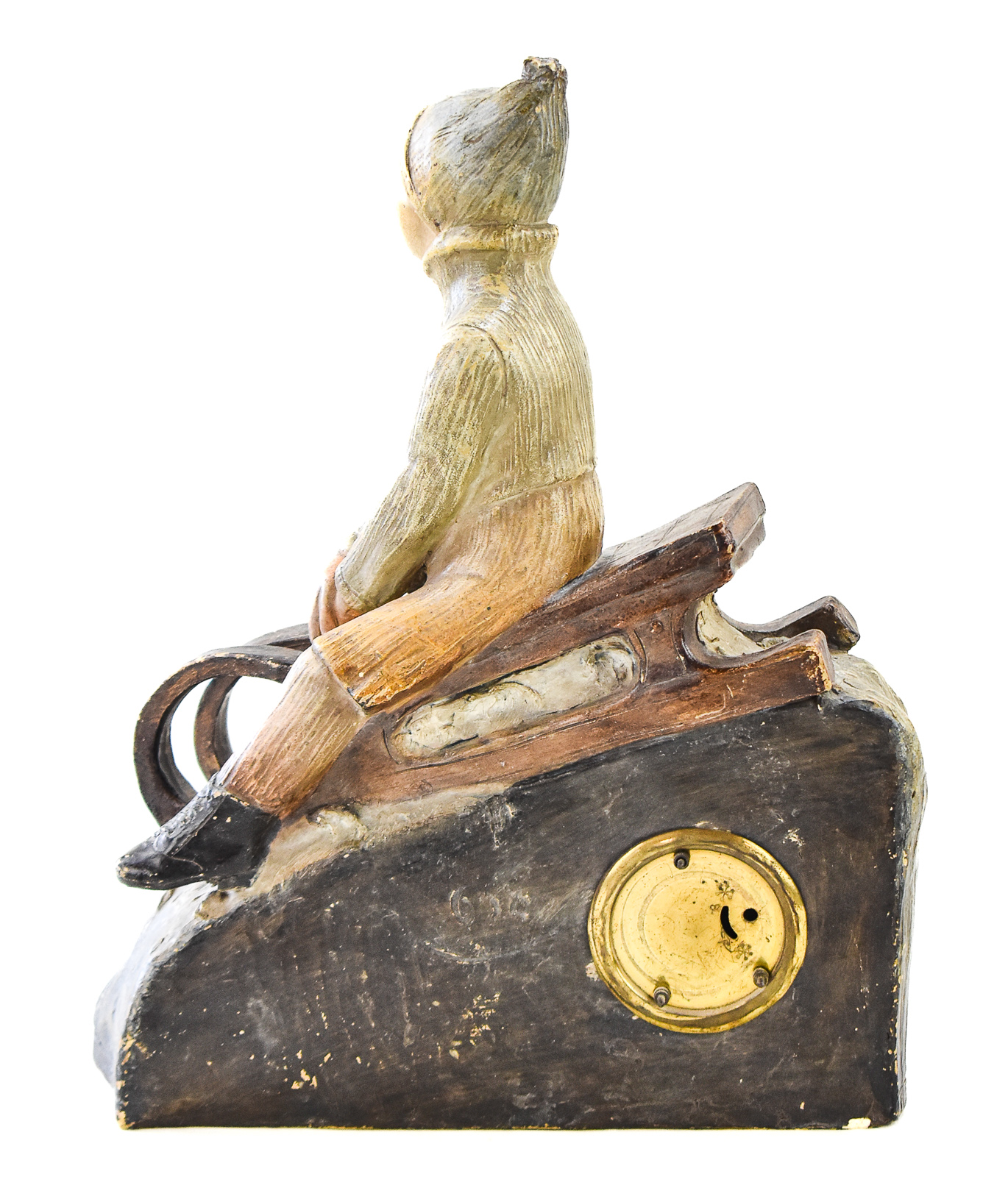 FIGURAL CHALKWARE MANTEL CLOCK OF CHILD RIDING SLED