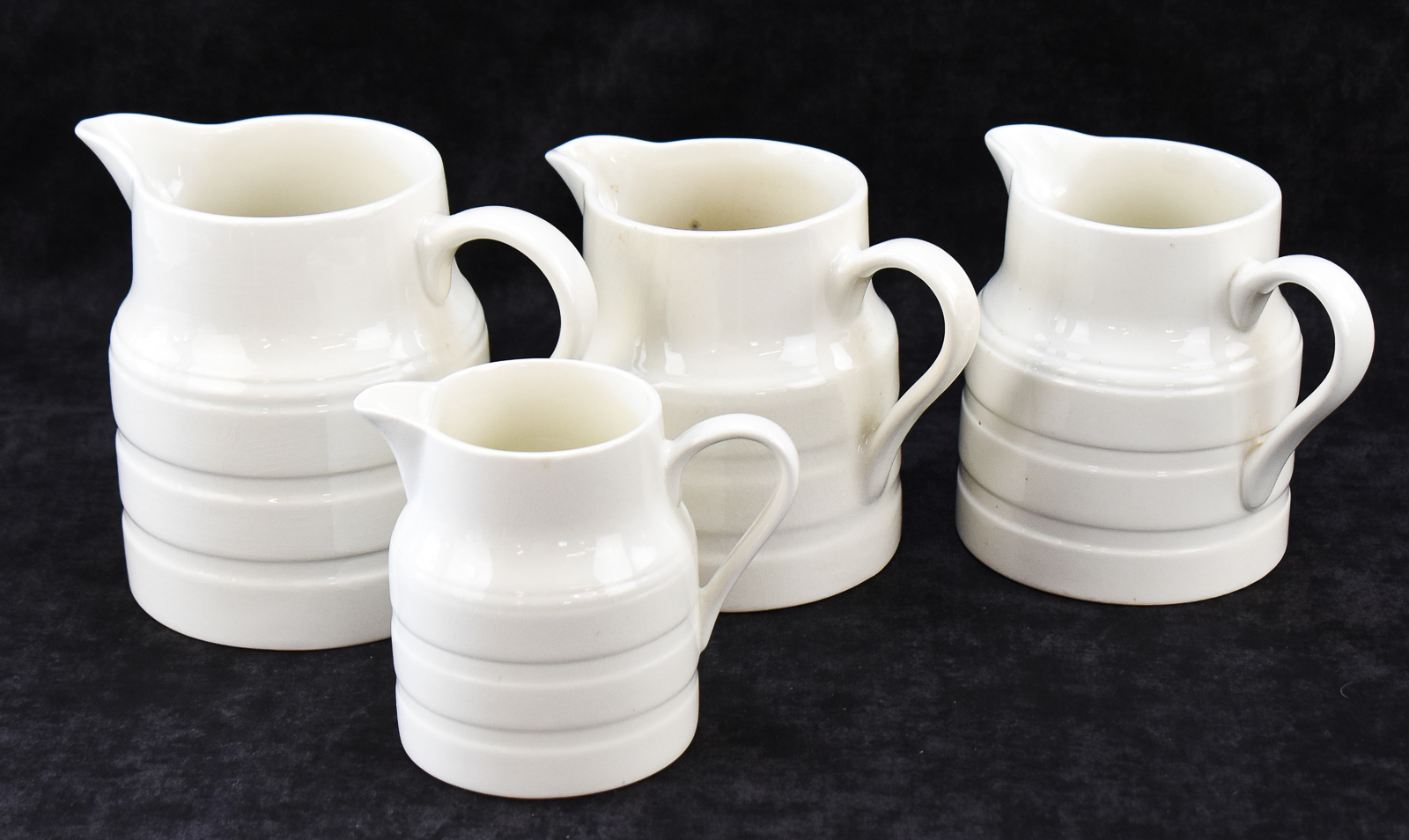 FOUR LORD NELSON POTTERY ENGLISH WHITE IRONSTONE PITCHERS