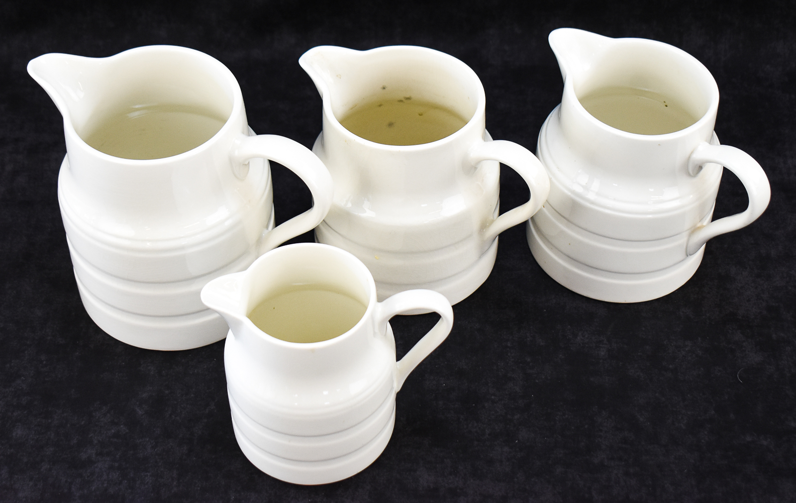 FOUR LORD NELSON POTTERY ENGLISH WHITE IRONSTONE PITCHERS