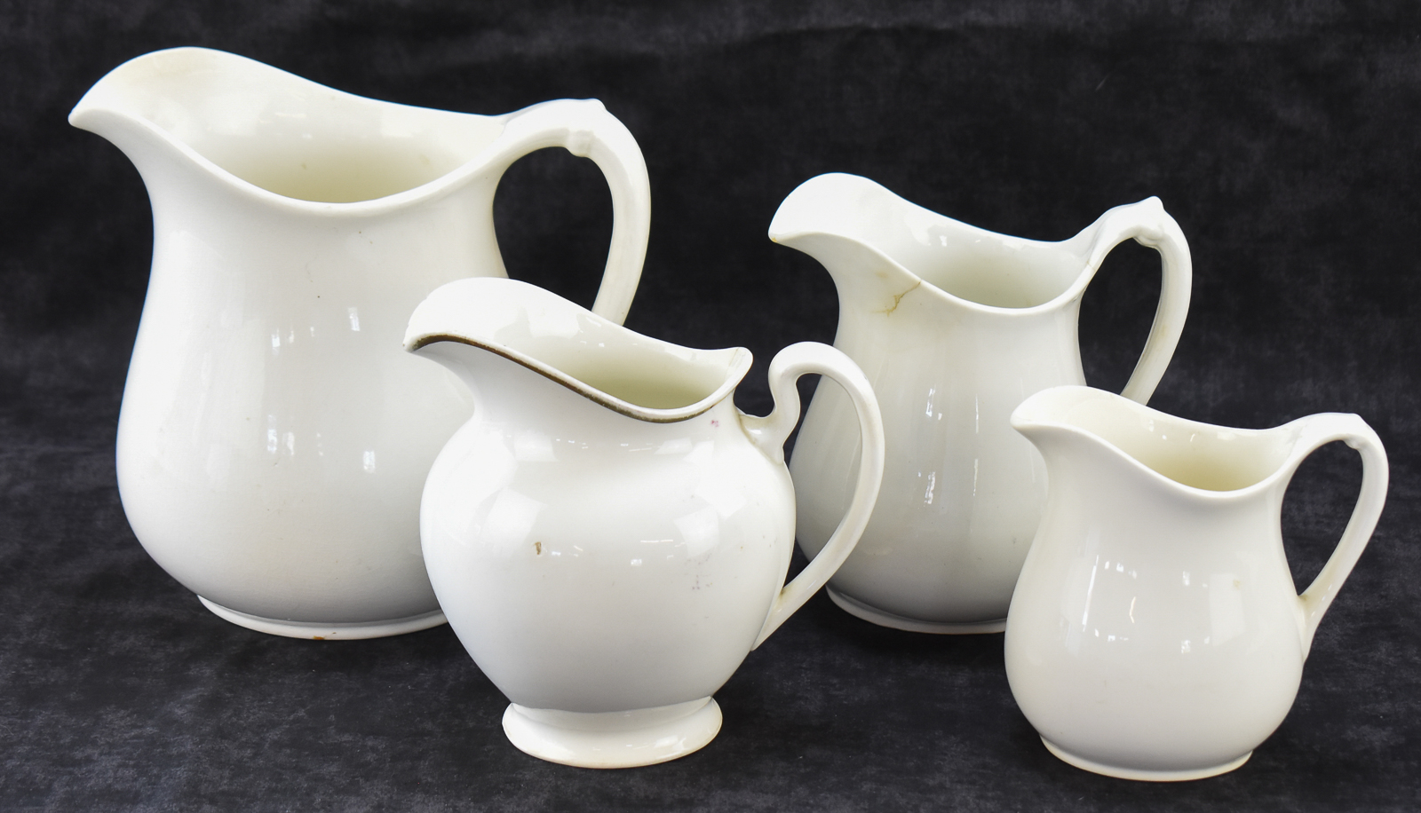 FOUR W.S. GEORGE "WHITE GRANITE" PITCHERS