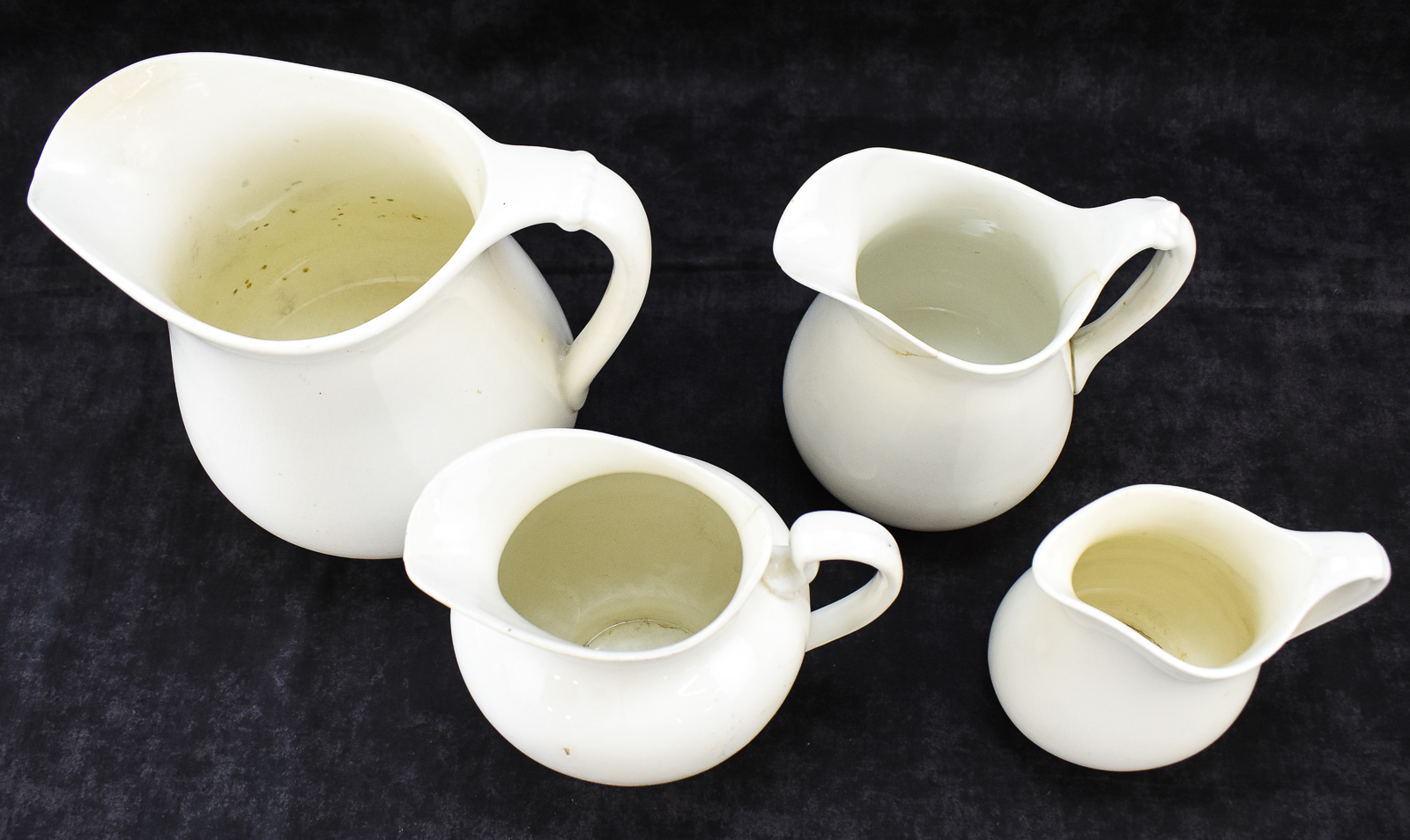 FOUR W.S. GEORGE "WHITE GRANITE" PITCHERS