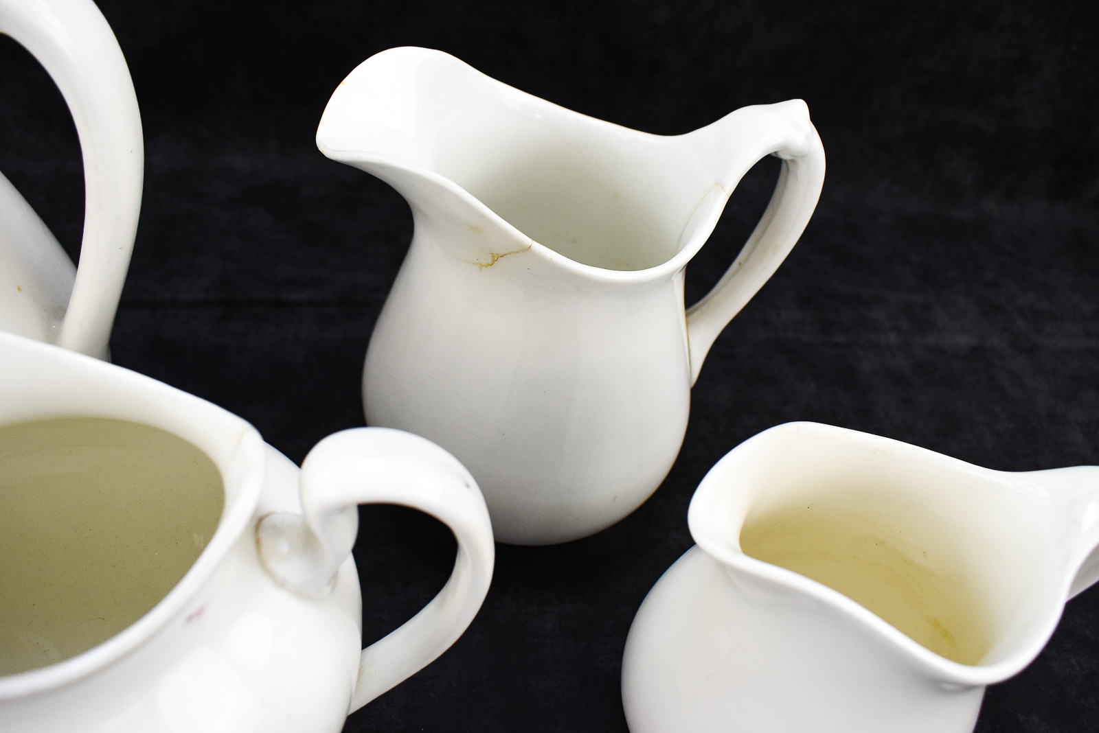FOUR W.S. GEORGE "WHITE GRANITE" PITCHERS
