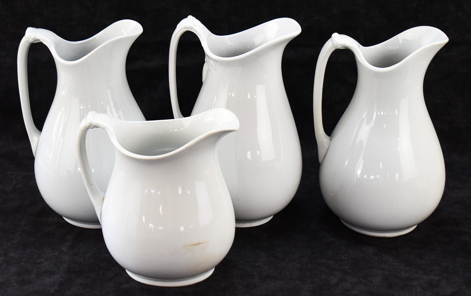 FOUR ENGLISH WHITE IRONSTONE PITCHERS: J & G MEAKIN, WEDGWOOD