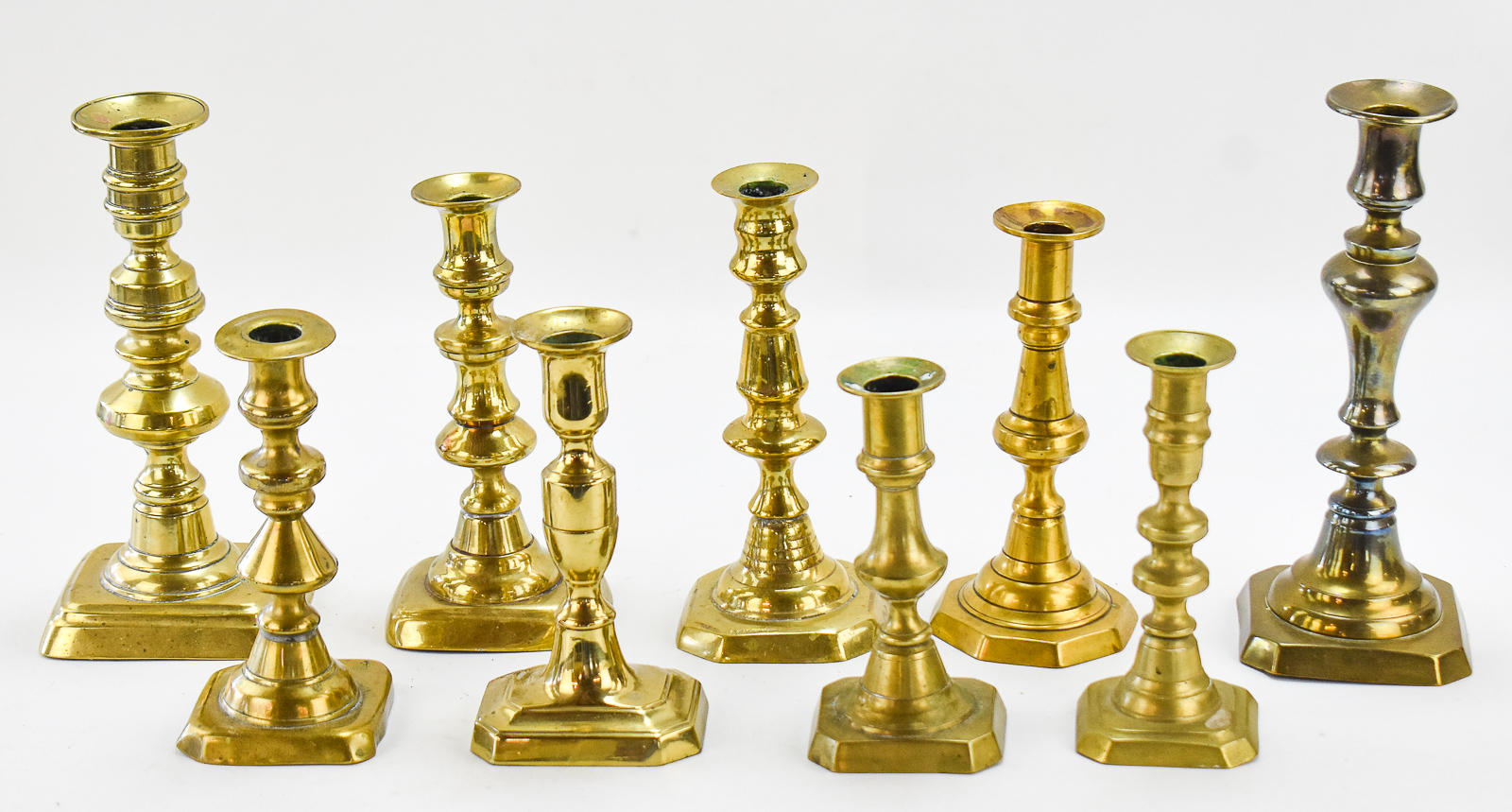 NINE ENGLISH-STYLE BRASS CANDLESTICKS