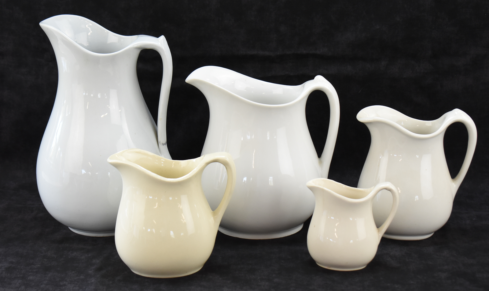 FIVE WHITE IRONSTONE PITCHERS