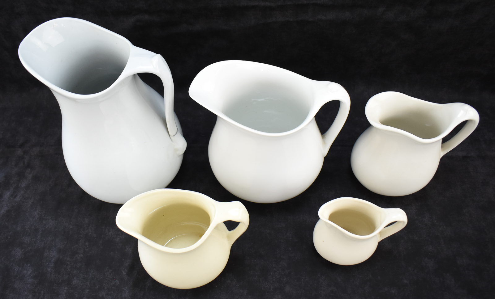FIVE WHITE IRONSTONE PITCHERS