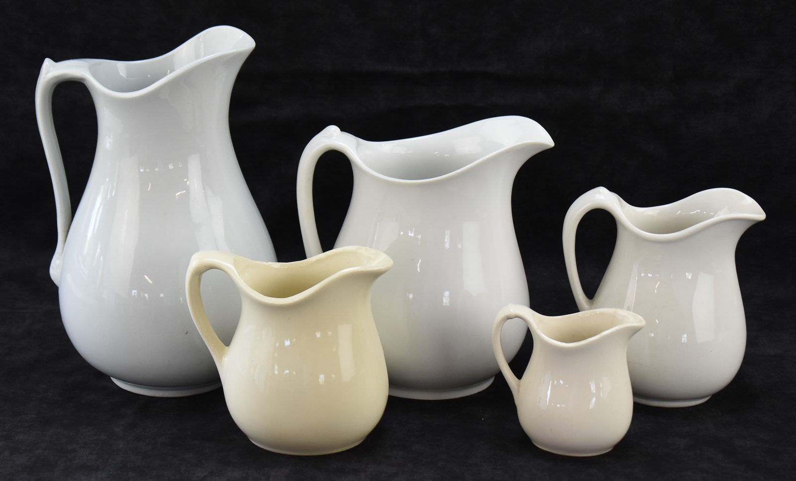 FIVE WHITE IRONSTONE PITCHERS