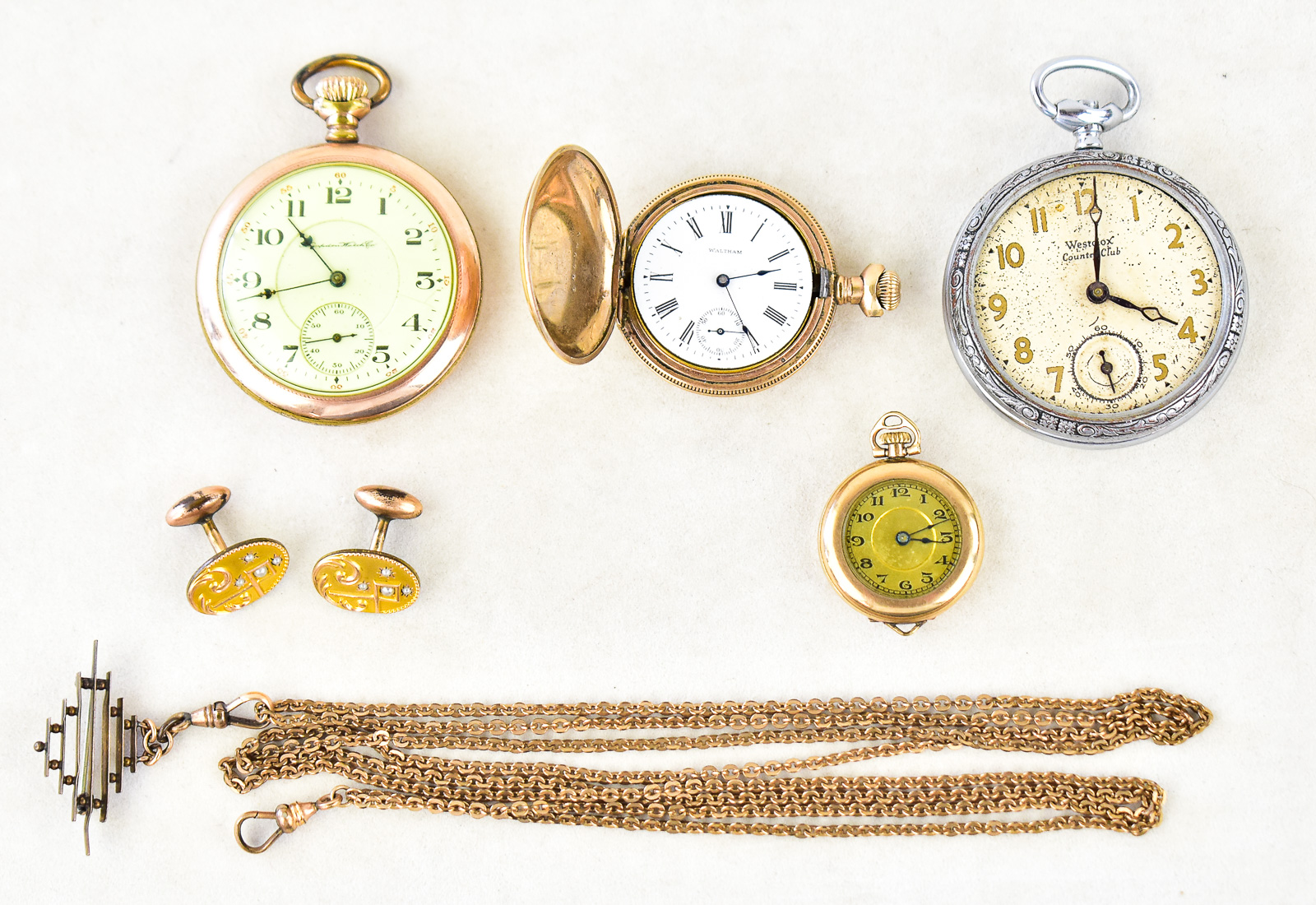 THREE GOLD-PLATED POCKET WATCHES & ACCESSORIES: HAMPDEN, WALTHAM, A. RACINE