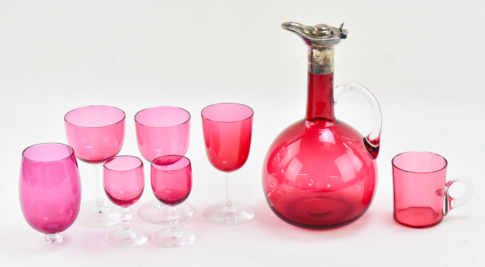 ENGLISH CRANBERRY GLASS DECANTER W/ STERLING SPOUT, EUSTACE G. PARKER 1899, & CRANBERRY GLASSES