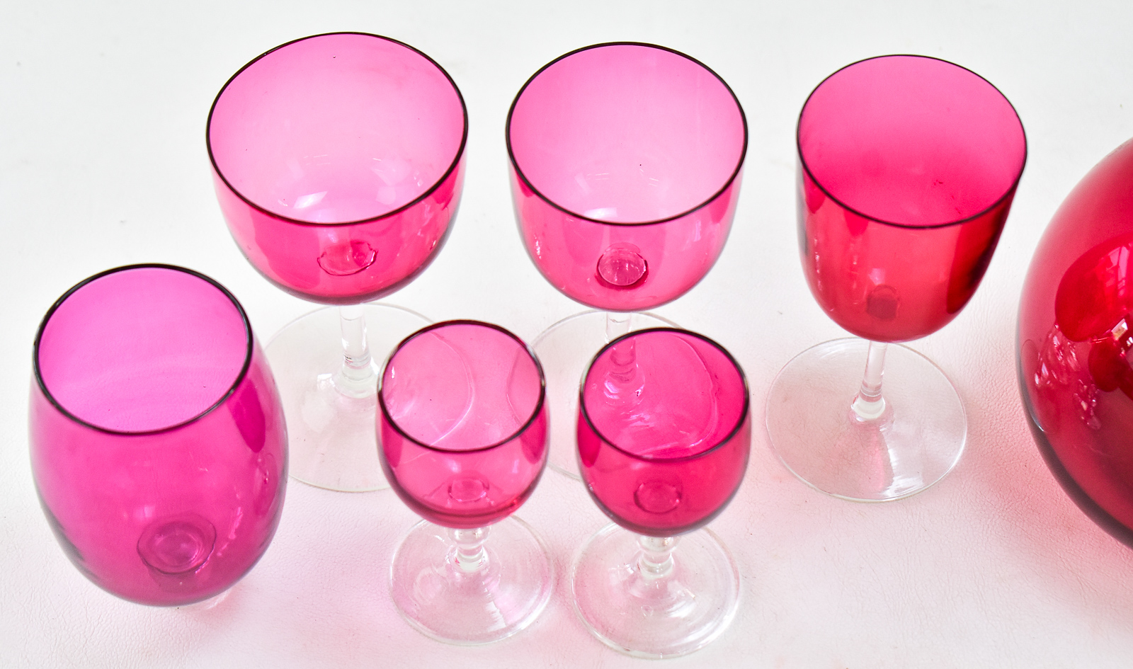 ENGLISH CRANBERRY GLASS DECANTER W/ STERLING SPOUT, EUSTACE G. PARKER 1899, & CRANBERRY GLASSES