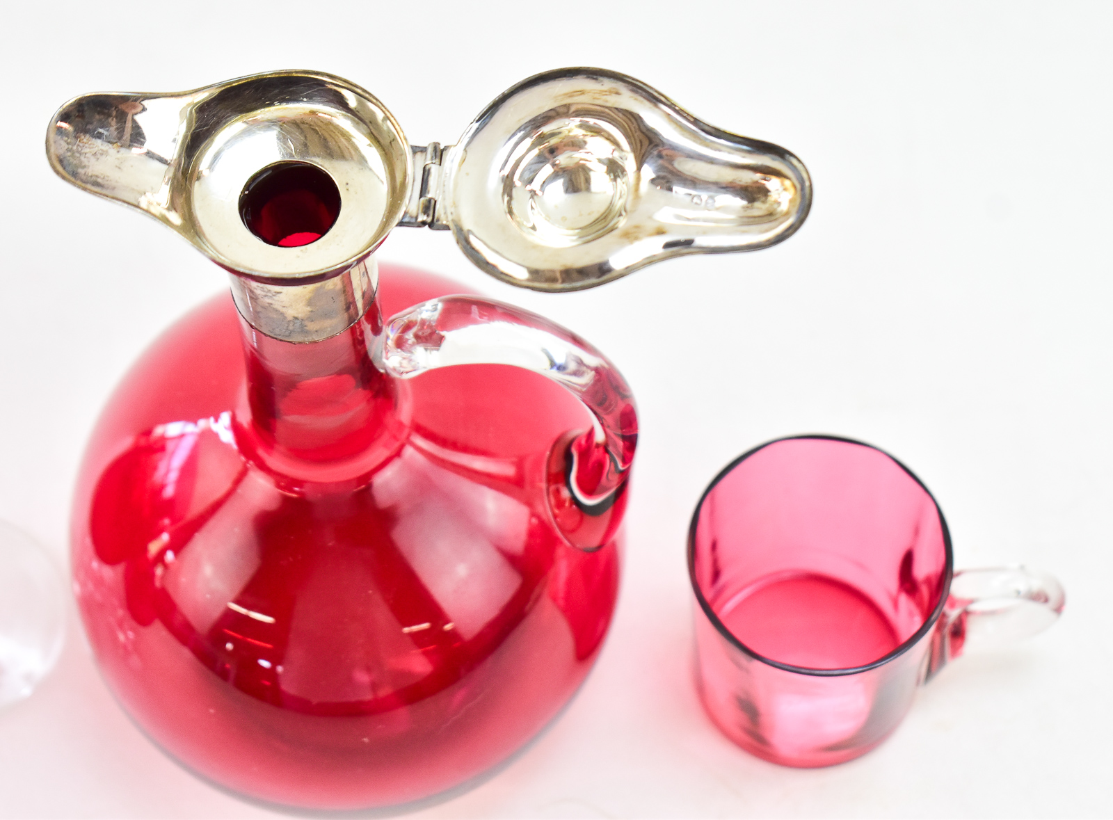 ENGLISH CRANBERRY GLASS DECANTER W/ STERLING SPOUT, EUSTACE G. PARKER 1899, & CRANBERRY GLASSES